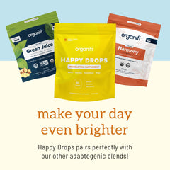 Organifi Happy Drops gomita junto a regla para comparación de tamaño claro