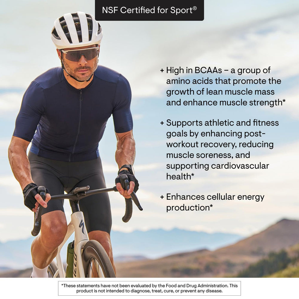 THORNE Amino Complex berry in glass illustrating easy mix with water.