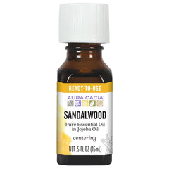 Aura Cacia frontal del envase mostrando la mezcla lista y beneficios aromáticos