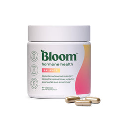 Bloom Nutrition frasco frontal mostrando etiqueta y beneficio de equilibrio