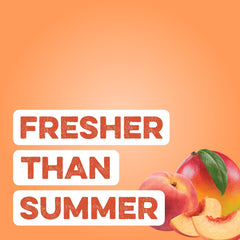 Vaso con bebida Peach Mango mezclada en mano, Clean Simple Eats ofrece sabor refrescante