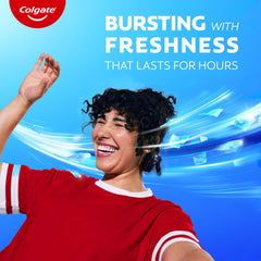 Colgate MaxFresh tubo junto a regla mostrando tamaño de viaje