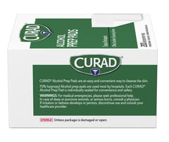 Curad almohadilla junto a una moneda para comparar tamaño mediano
