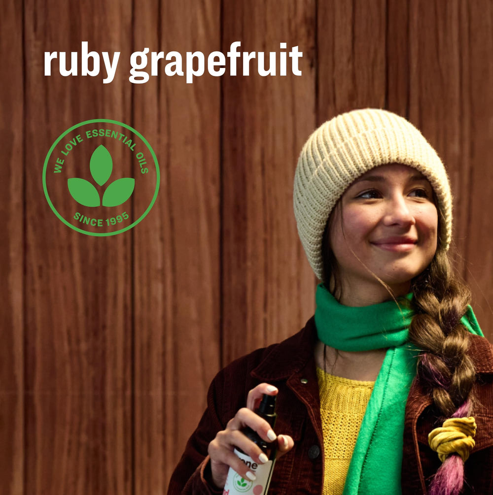 Manos aplicando Everyone Ruby Grapefruit en spray para higiene rápida