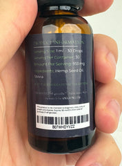 GreenIVe frasco junto a una moneda para comparar tamaño y portabilidad