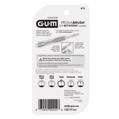 GUM Proxabrush junto a una moneda para mostrar tamaño compacto y portabilidad