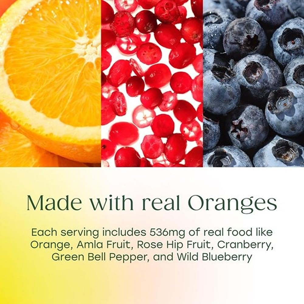 Naranja y arándano junto a frasco MegaFood Complex C resaltando ingredientes de alimentos reales