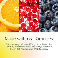 Naranja y arándano junto a frasco MegaFood Complex C resaltando ingredientes de alimentos reales