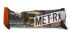 MET-Rx barra junto a pesas sugiriendo uso como snack pre o post entrenamiento