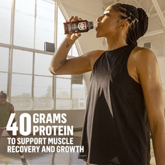 Muscle Milk comparación de tamaño junto a una botella de agua para escala clara