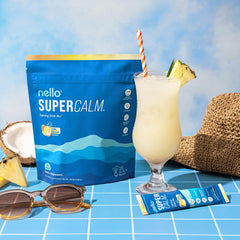 Vaso con bebida Nello Supercalm sabor Piña Colada, refrescante antes de dormir