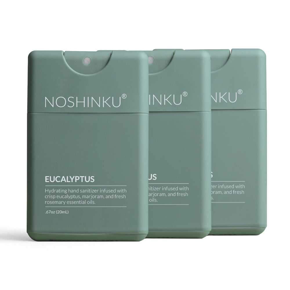 Noshinku paquete frontal mostrando tres sprays recargables y beneficio ecológico