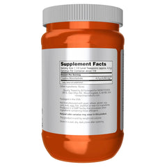 NOW Foods polvo de creatina en cuchara resaltando textura fina