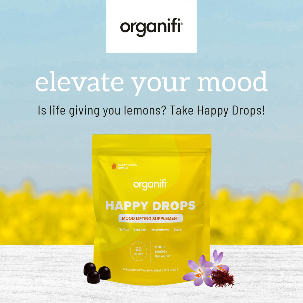 Organifi Happy Drops ingredientes naturales en mesa mostrando transparencia
