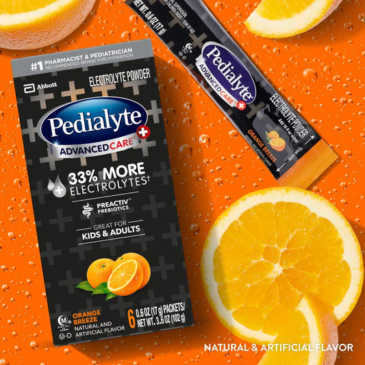 Pedialyte sobre abierto con polvo naranja y textura visible para mezcla rápida