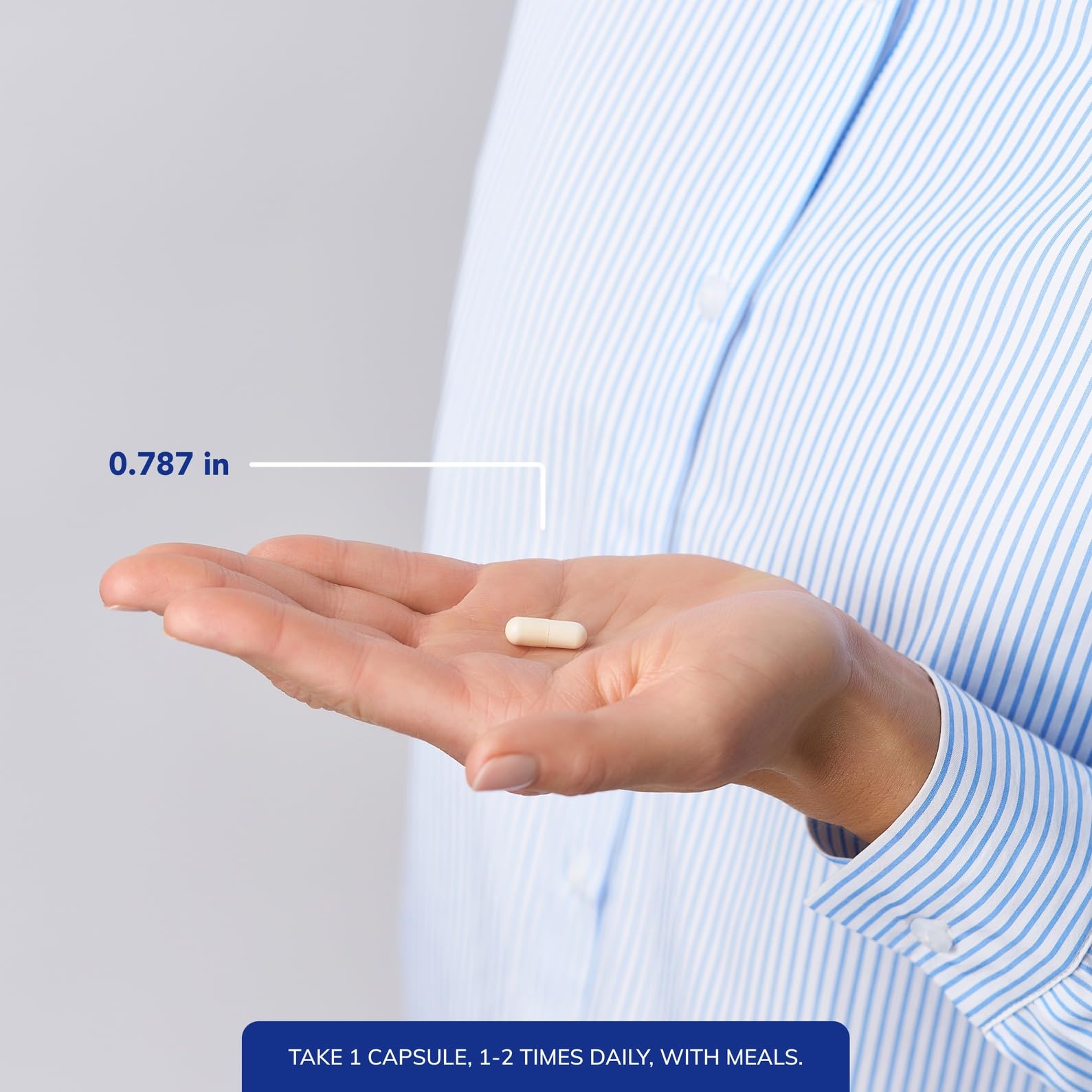Pure Encapsulations cápsula junto a moneda para comparación de tamaño práctico