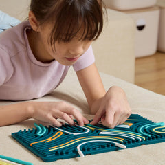 Manos de niño usando Pushpeel XL para empujar y tirar, promueve motricidad fina
