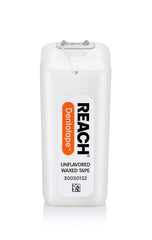 Comparación de tamaño de Reach Dentotape junto a una regla para referencia