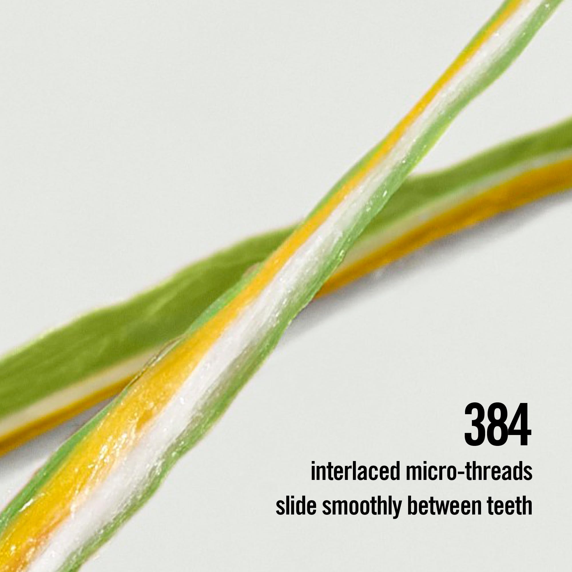Reach hilo dental en uso entre dientes, deslizamiento suave y frescor de menta