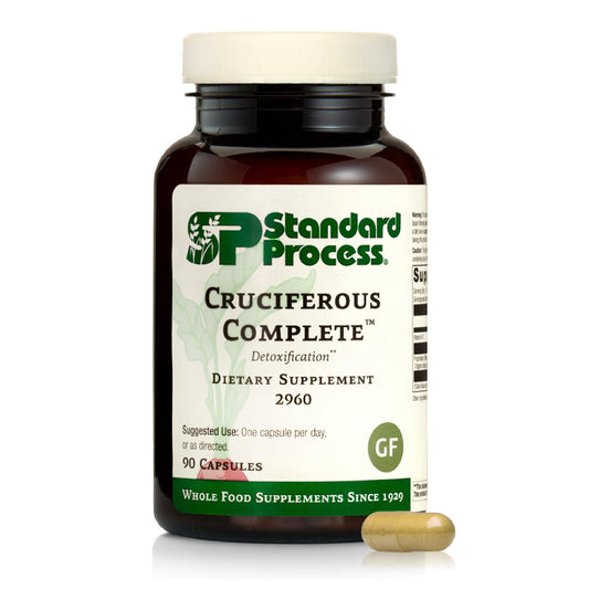 Standard Process envase frontal mostrando Cruciferous Complete y beneficios claros