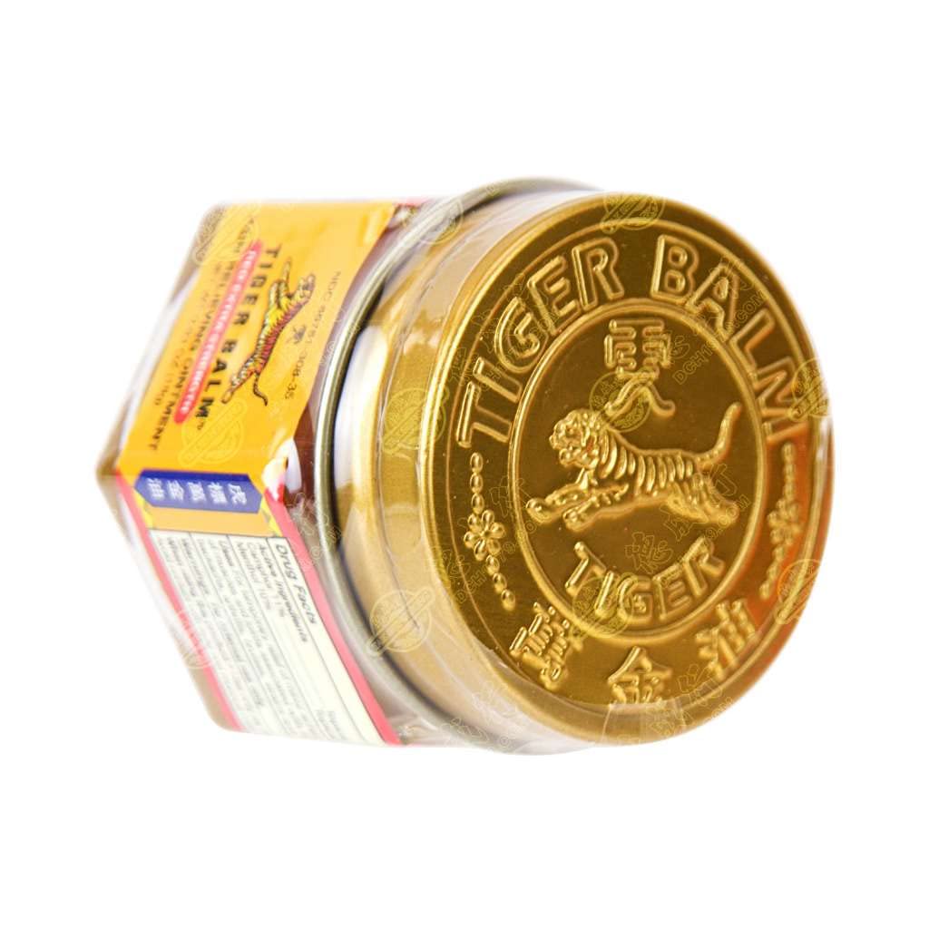 Tiger Balm junto a una moneda para comparar tamaño portátil útil