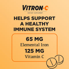 Vitron-C tableta en mano para comparar escala y manejo sencillo