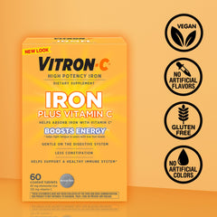 Vitron-C tableta junto a vaso de agua para uso diario práctico