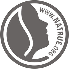 Weleda aceite perineal envase 50 ml junto a objetos, tamaño práctico para maternidad